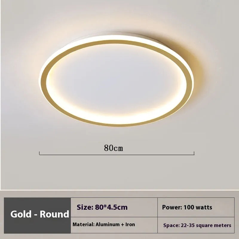 Modern minimalist circular LED ceiling lamp in black finish with integrated lights, shown in a bedroom setting.