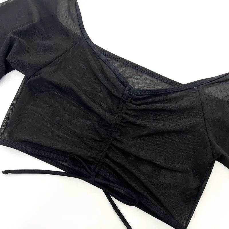 Black long sleeve mesh bikini four-piece swimsuit set for women on a mannequin.
