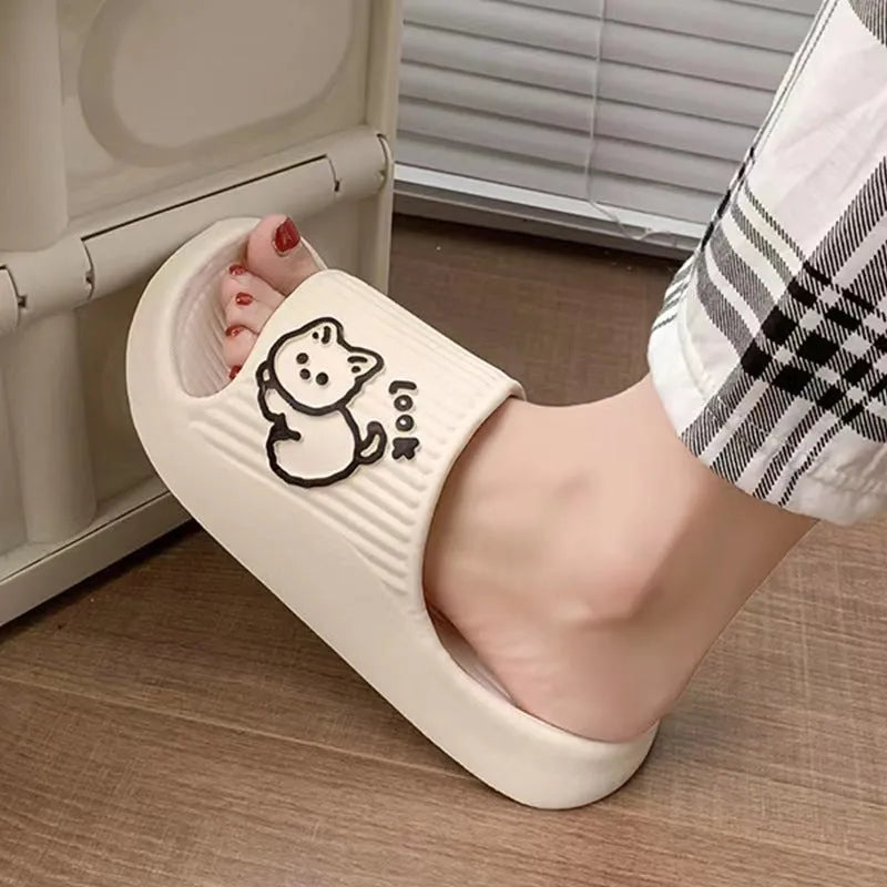 Women's green cat slippers with thick platform sole and flip-flop design on a white background.