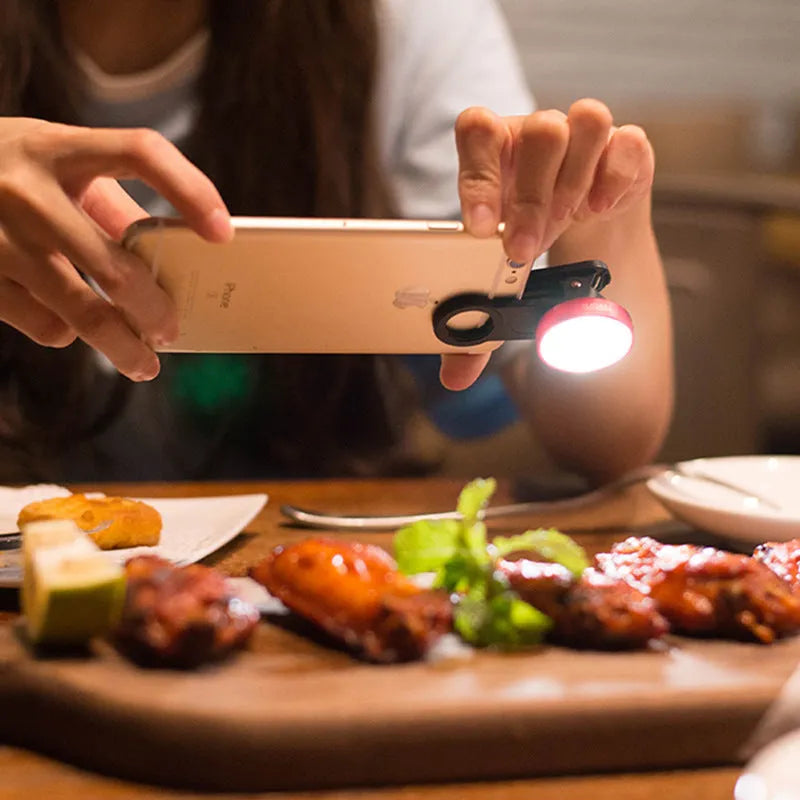 Smartphone wide-angle camera lens and colourful LED selfie light kit in black, red, and silver grey.