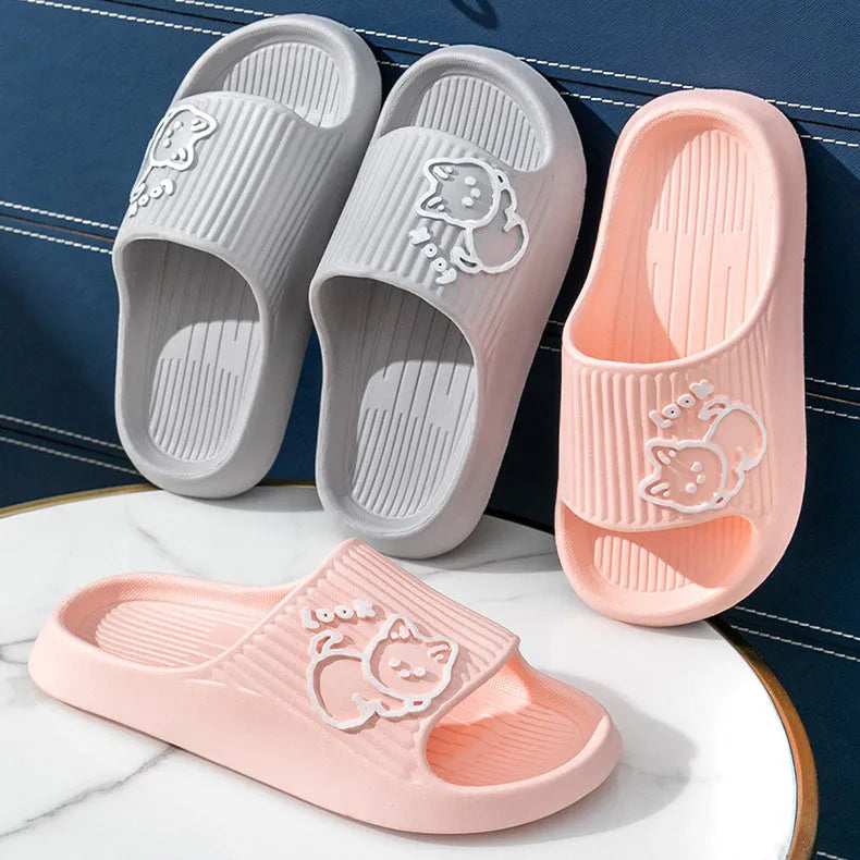 Women's green cat slippers with thick platform sole and flip-flop design on a white background.