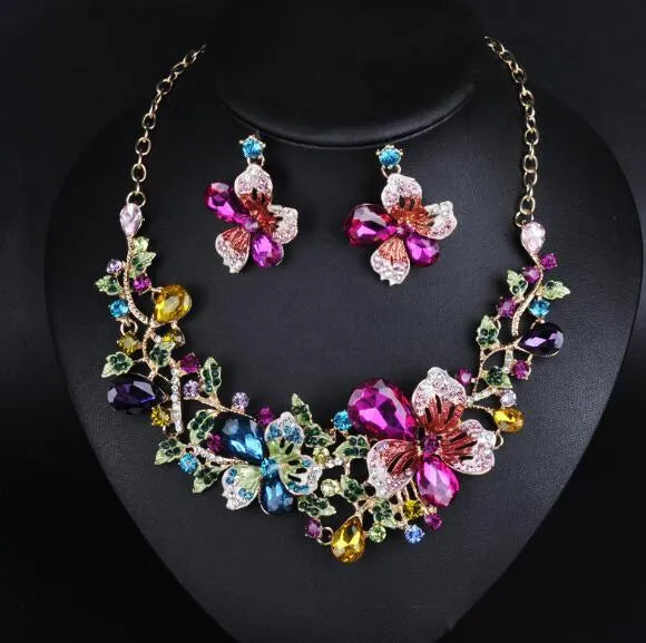 Crystal exaggeration chain necklace with gold-tone finish and faceted crystal links on a white background