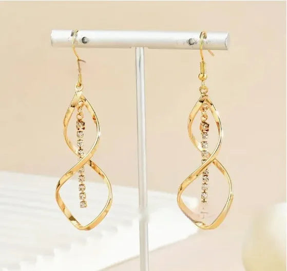 Gold electroplated spiral design alloy earrings with geometric elliptical shape for women