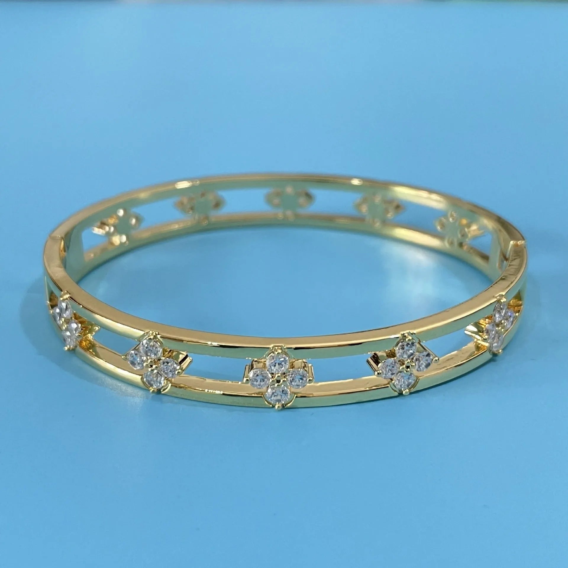 Gold and silver hollow women's bracelets with four-leaf clover charm and zircon stones.