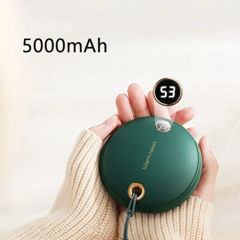 Green portable power bank with digital display, functioning as a hand warmer, shown next to its USB Type-C cable.