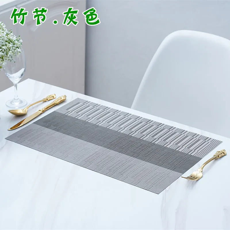 Non-slip PVC dish mat in gradient bamboo pattern protecting a kitchen countertop.