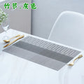 Non-slip PVC dish mat in gradient bamboo pattern protecting a kitchen countertop.