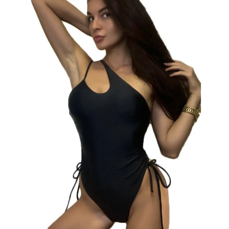 Black sleeveless women's dress with sloping shoulders and lacing detail on a tight fit.