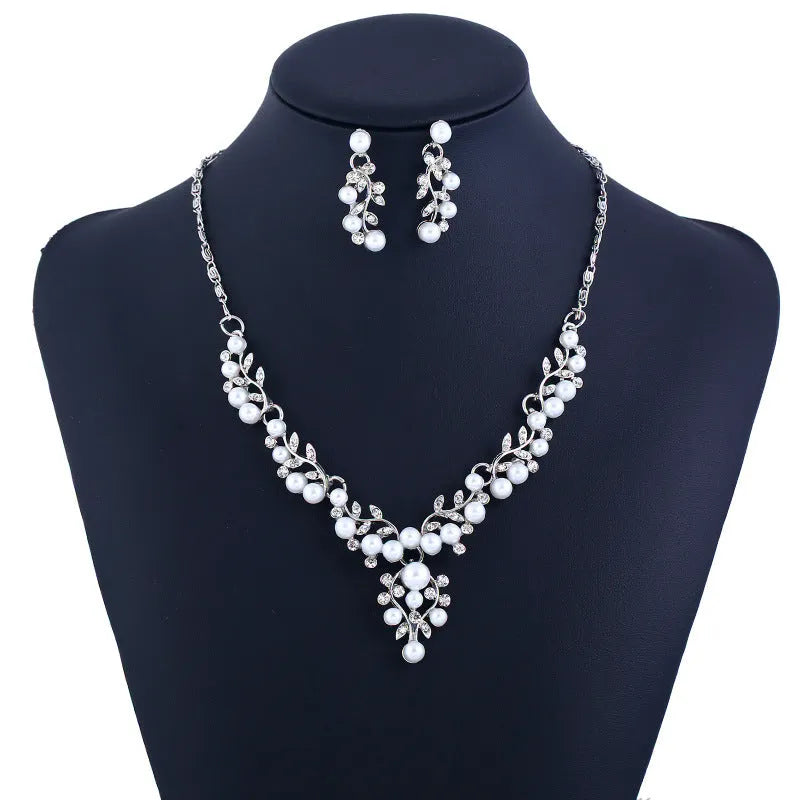 Fashion chain set with earrings and necklace featuring simulated pearl and diamond accents in silver tone