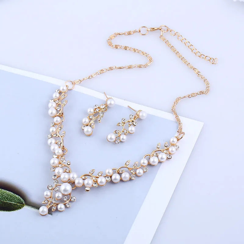 Fashion chain set with earrings and necklace featuring simulated pearl and diamond accents in silver tone
