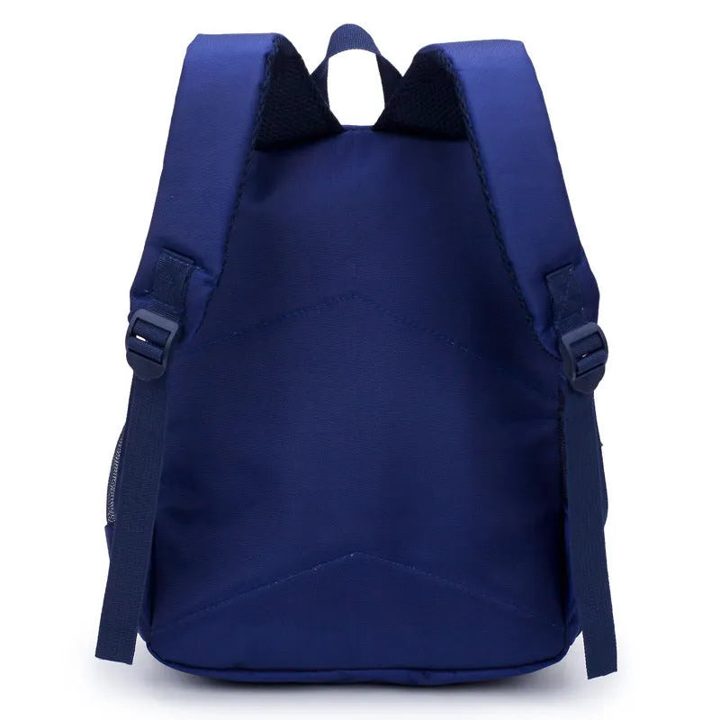 A deep blue children's school bag with a cartoon bear design on the front, showing the front pocket and adjustable straps.
