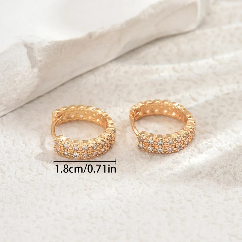Geometric copper ear studs with round, dot, and ring pattern elements in colour DE20288