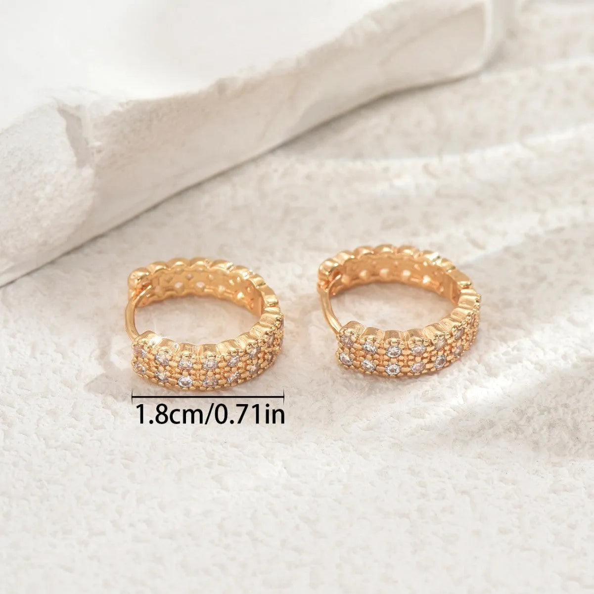 Geometric copper ear studs with round, dot, and ring pattern elements in colour DE20288