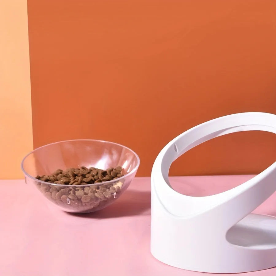 Clear plastic elevated cat food bowl with a tilted feeding platform.