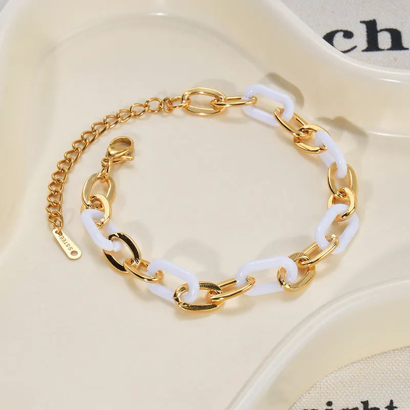 Silver stainless steel bracelet with a double-layer heart pendant featuring dark resin insets
