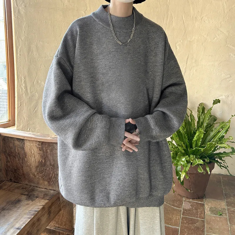 A man's solid colour round neck pullover sweater with long sleeves in a loose, casual fit.