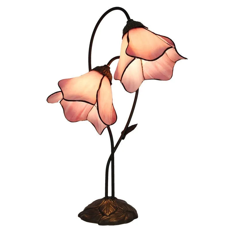 Retro American style desk lamp with lotus glass shade on wooden table.