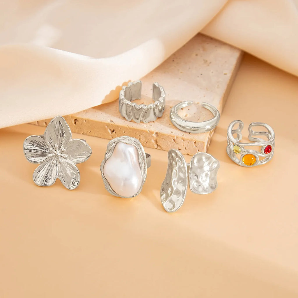 Women's open ring with liquid lava flower design, imitation pearl detail, available in gold or silver
