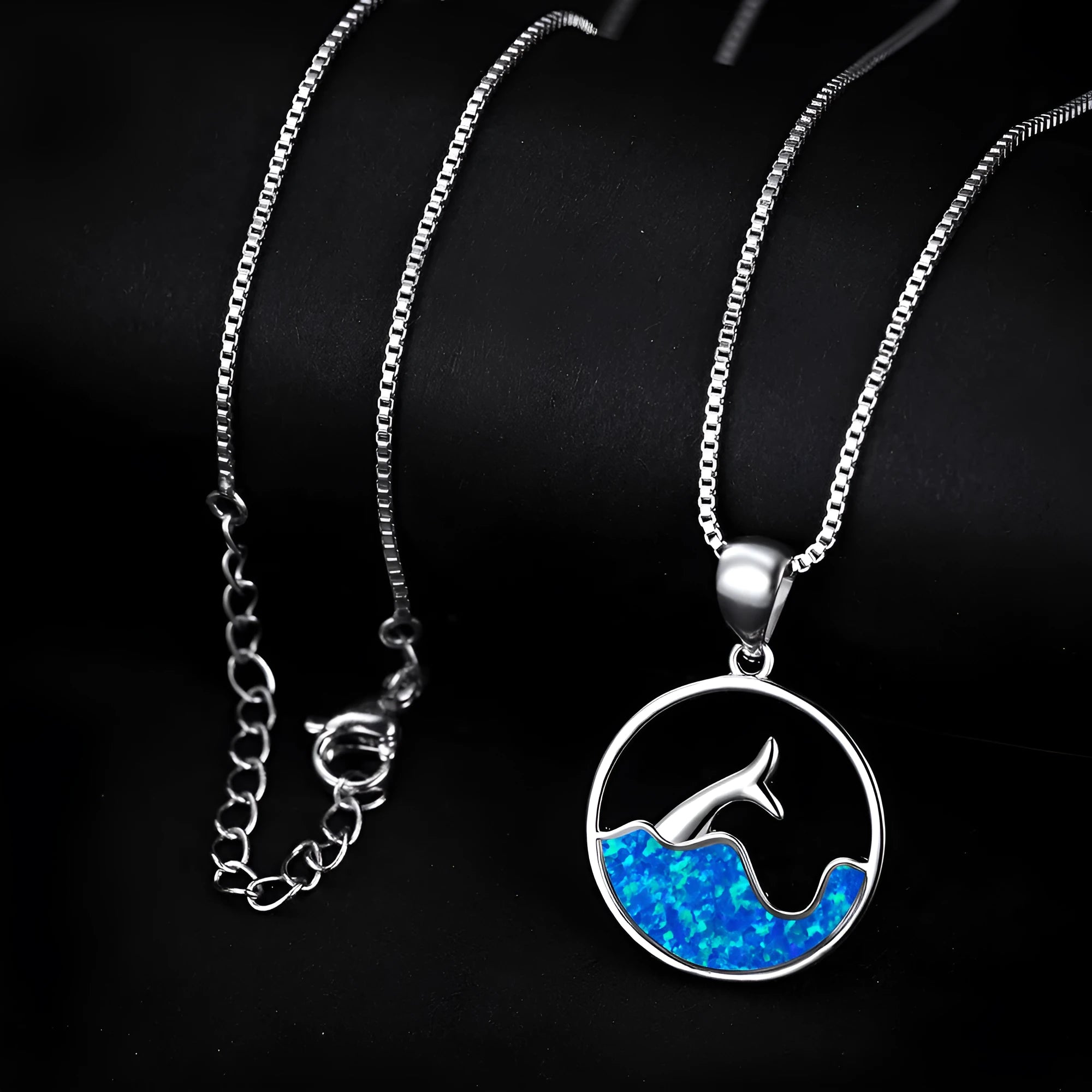 Geometric sea fishtail pendant necklace with a round blue opal and white gold electroplated finish.