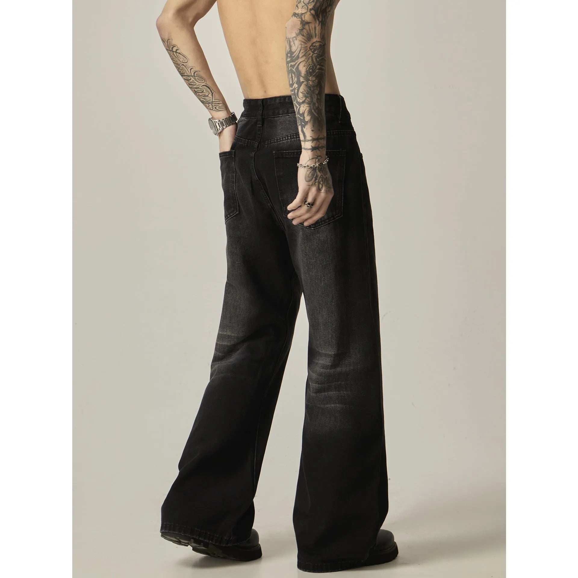 Black loose straight retro jeans with zipper fly on size chart background
