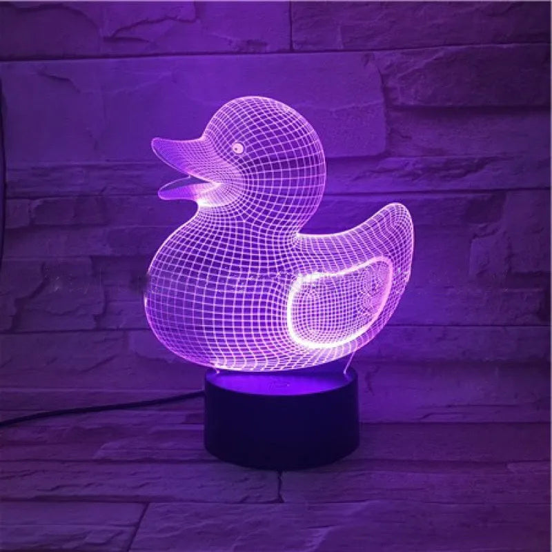 Little yellow duck 3D night light with colour-changing LED display on an ABS base, showing remote control.