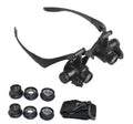 Black hands-free magnifying glasses with LED lights and multiple interchangeable lenses for precision repair work.