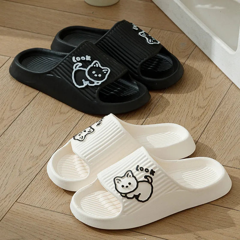 Women's green cat slippers with thick platform sole and flip-flop design on a white background.