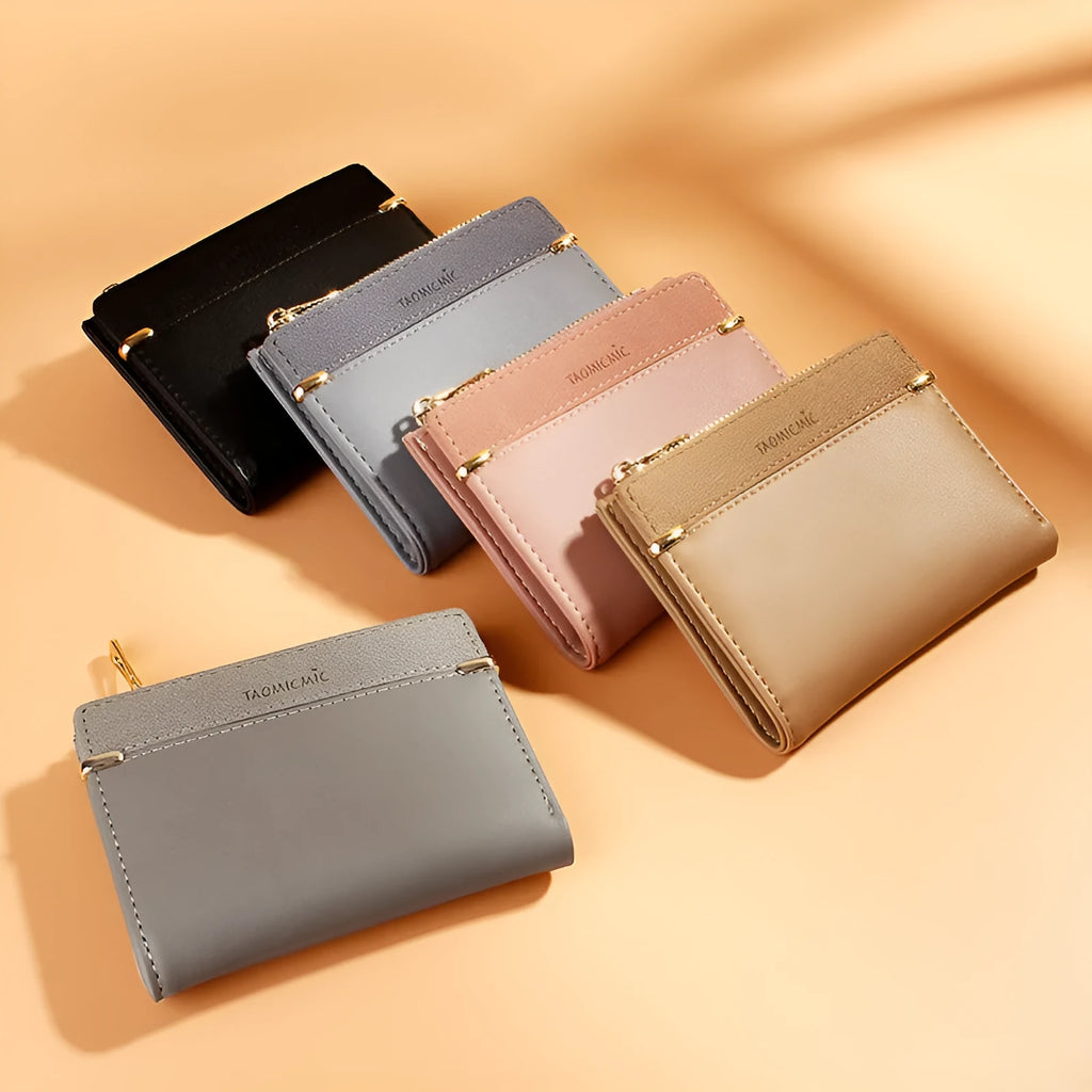 Short black ladies wallet with zipper, open to show multiple card slots, bill holder, and change compartment.