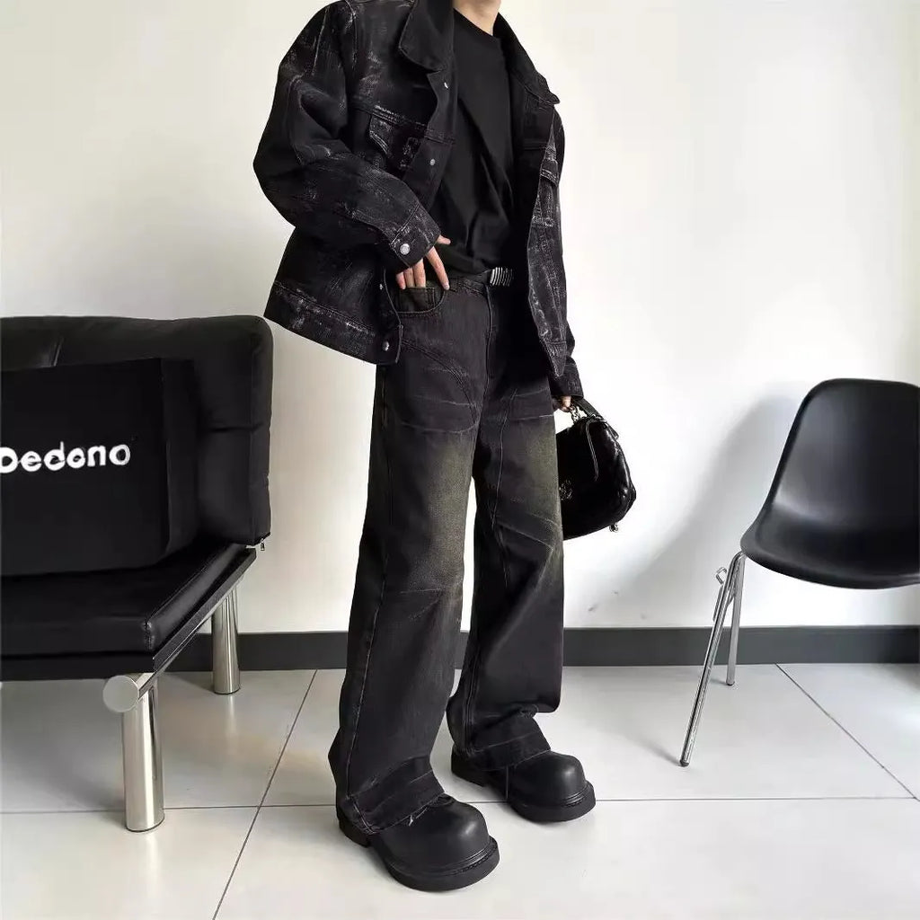 Washed black straight denim trousers with deconstructed dirty mud texture and zipper fly