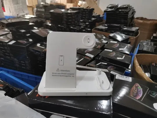 Folding 4-in-1 wireless charging stand in black showing smartphone charging vertically