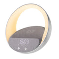 Beige wireless charging pad with digital clock, Bluetooth speaker, and ring of RGB LED mood lights.