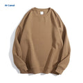 Loose-fitting, cotton, off-shoulder knit sweater in a solid colour on a hanger.