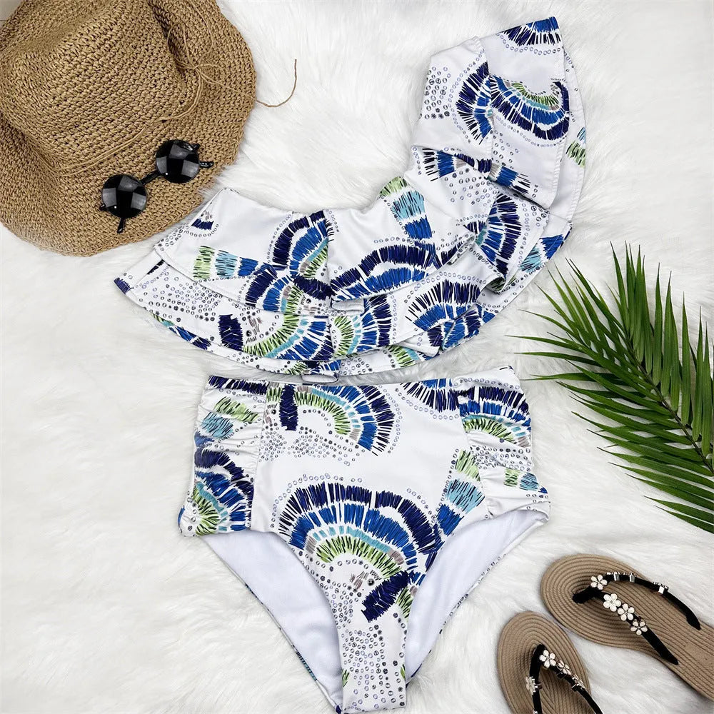 White women's one-shoulder bikini with a large double-layer lotus leaf detail and high thigh split.
