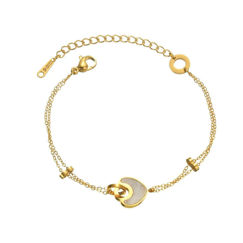 Silver stainless steel bracelet with a double-layer heart pendant featuring dark resin insets