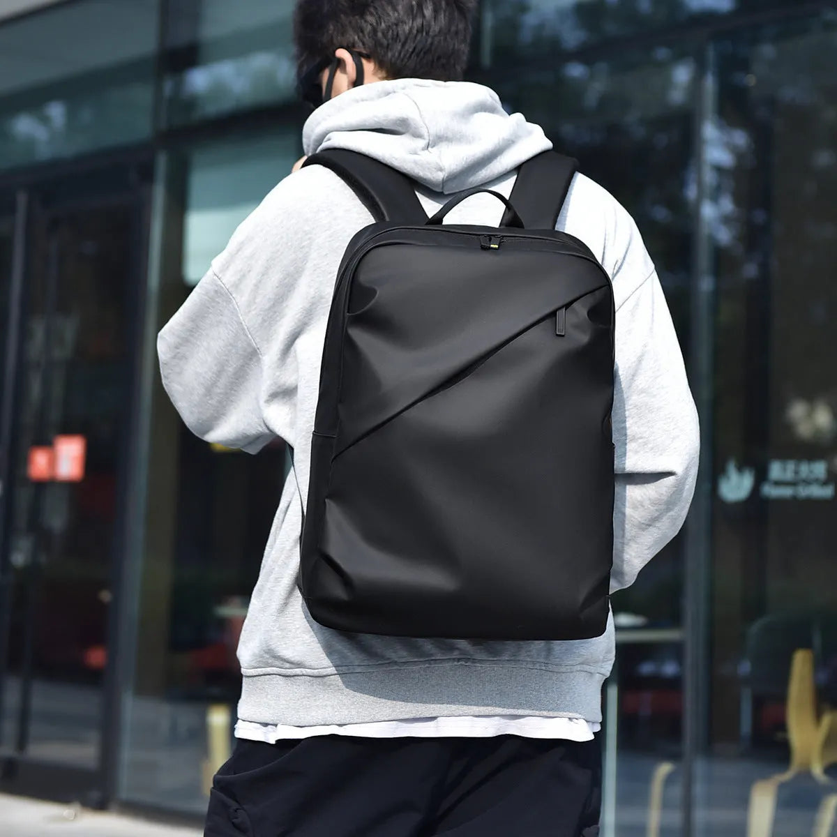 Men's waterproof PU leather backpack in black colour with computer compartment and sewing thread details