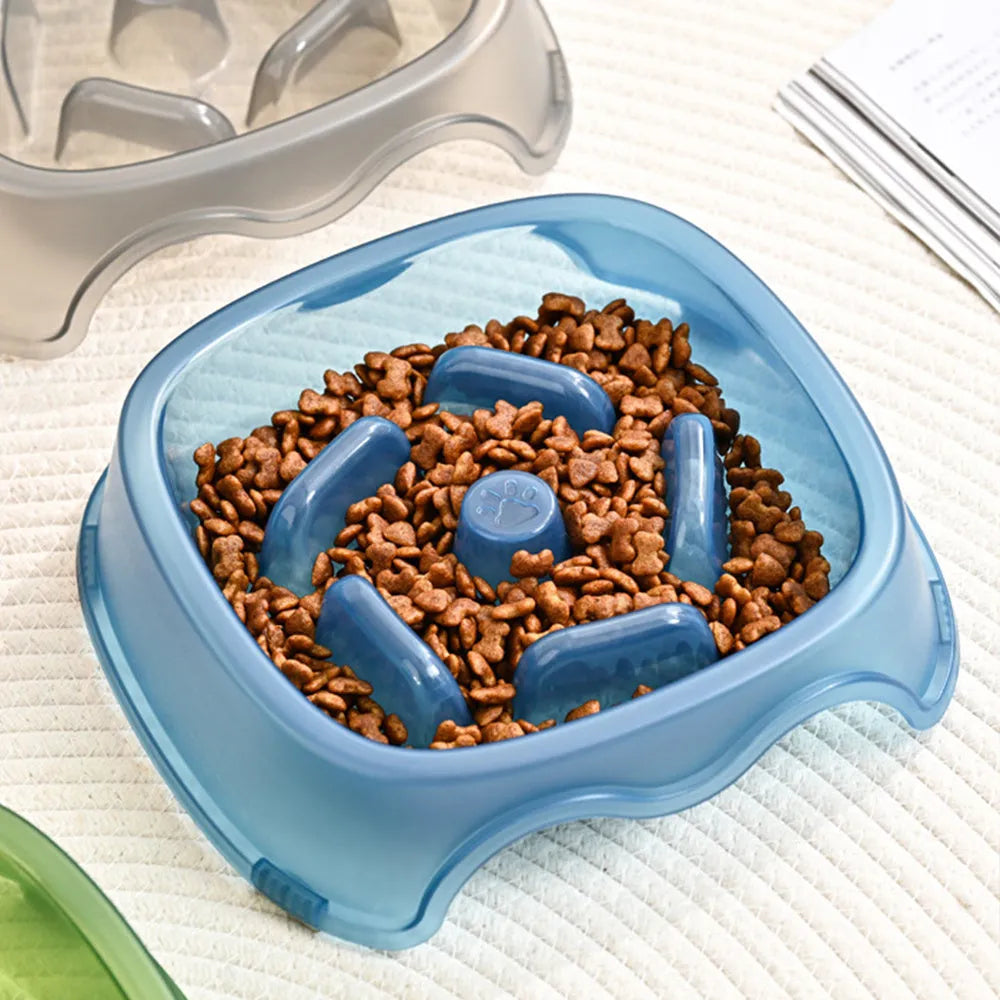 Blue plastic dog slow feeder bowl on a floor, designed to prevent choking by slowing eating pace.