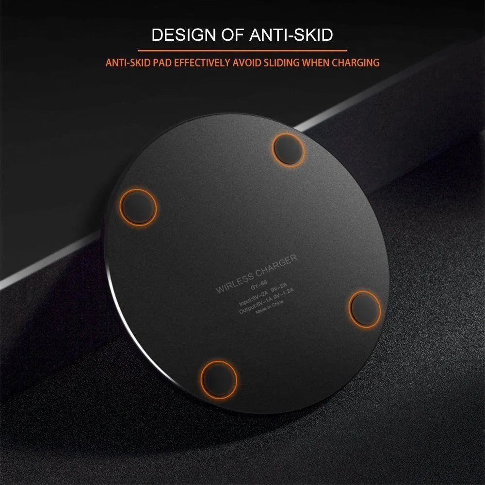 Ultra-thin black wireless charging pad with USB cable on desk
