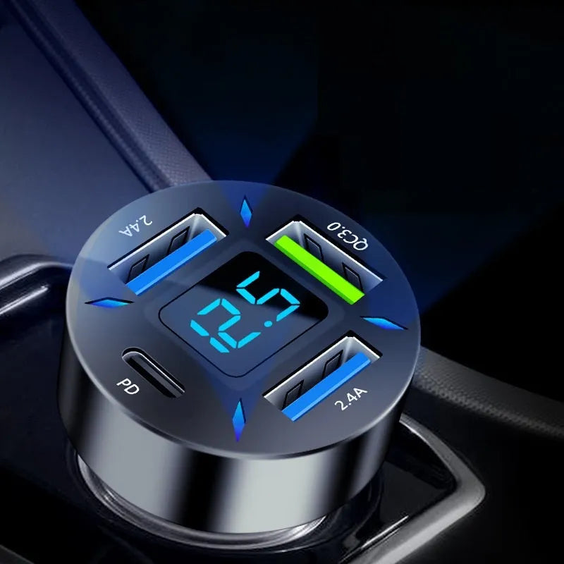 Black four-port USB car charger with LED digital display plugged into a car power outlet.
