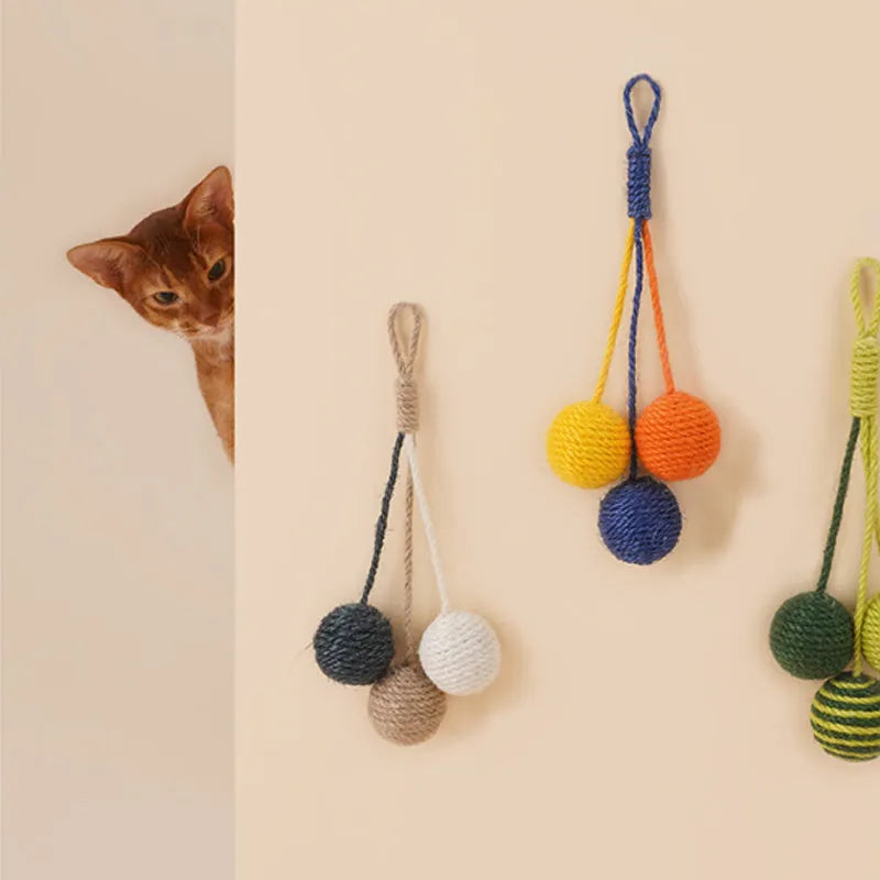 Cat toy set with blue and green teaser stick, red and yellow catnip balls, and a tumbling pet on a white background