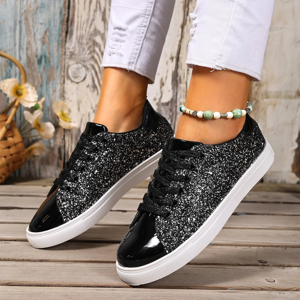 Women's plus size sequined board shoes in black with front lace-up fastening and flat rubber sole.