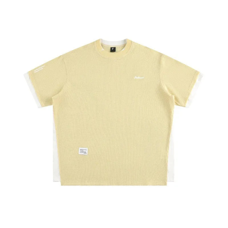 Loose fit grey waffle knit t-shirt with retro alphabet embroidery on the front.