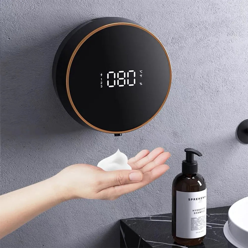 Black automatic foam soap dispenser mounted on wall with USB charging cable