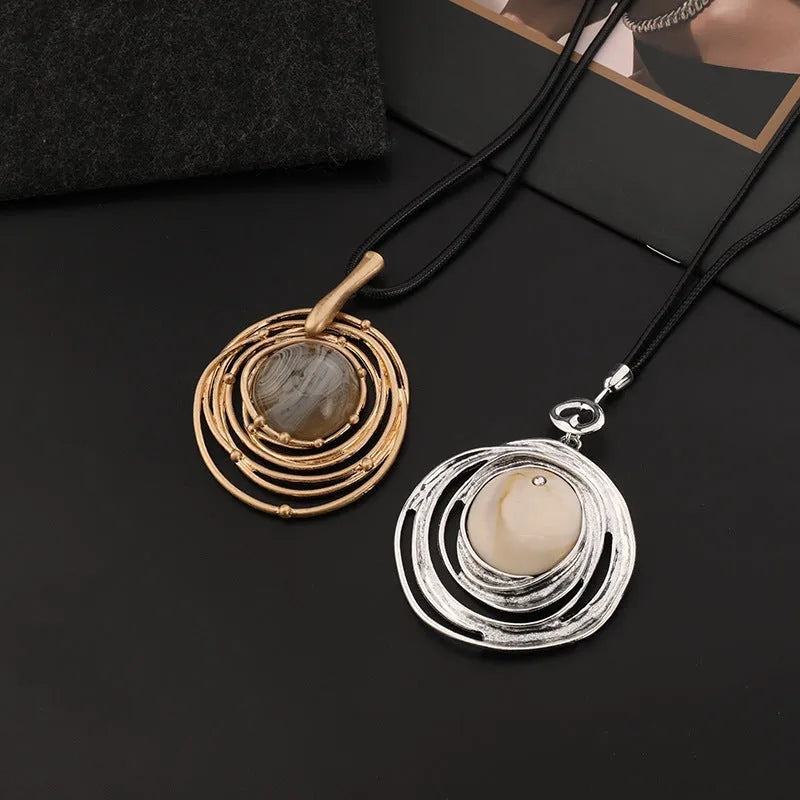 Gold geometric pendant sweater chain necklace with snakeskin texture rope on model