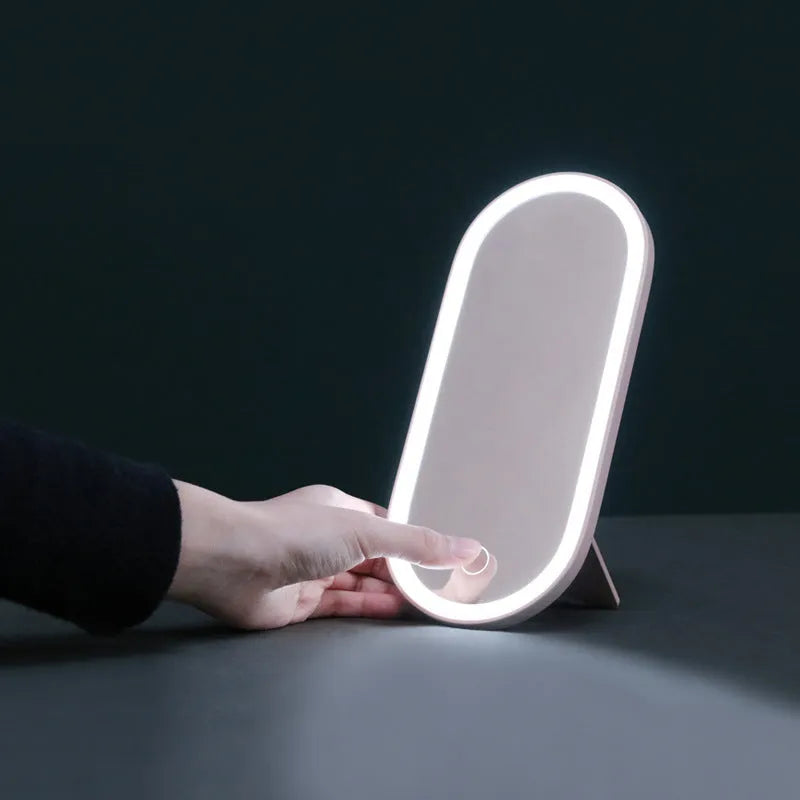 Portable LED mirror makeup organiser box with touch light, rotatable bracket, and soft handle in white