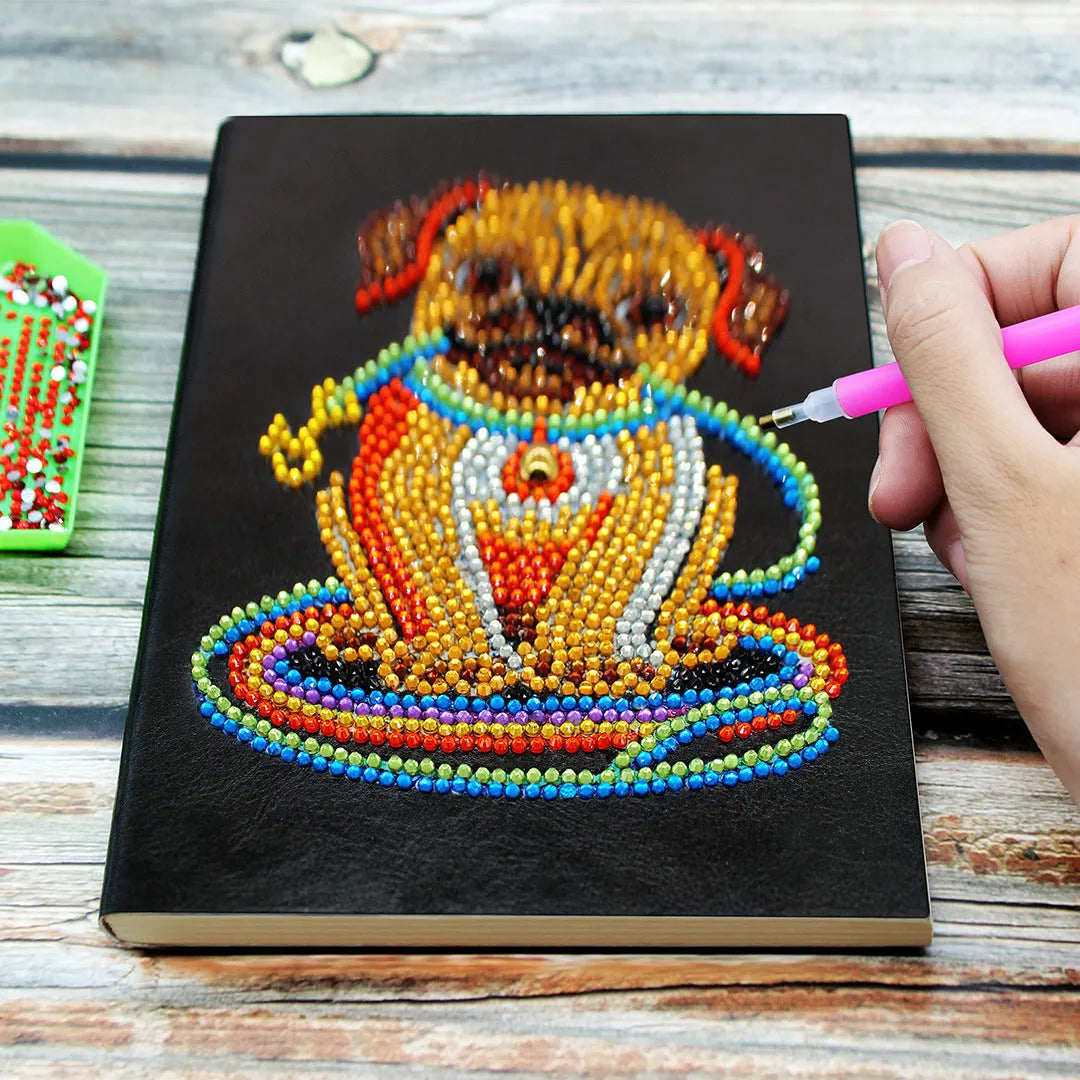 Black A5 hardback diamond painting notebook showing closed cover and spine.