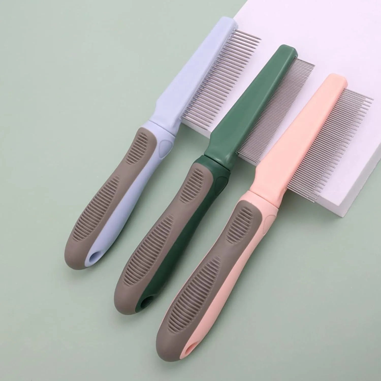Blue pet detangler comb with rubber handle and multiple needle teeth types for dog and cat grooming.