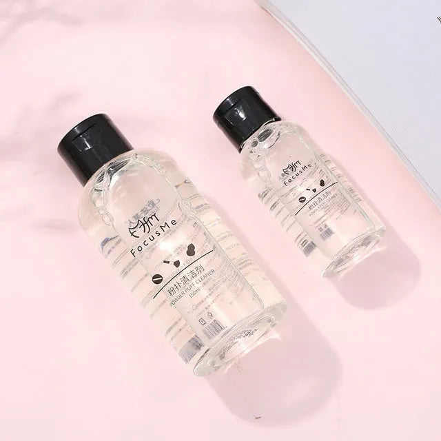 50ml makeup brush cleaning liquid in a clear bottle with a white cap, next to a makeup brush