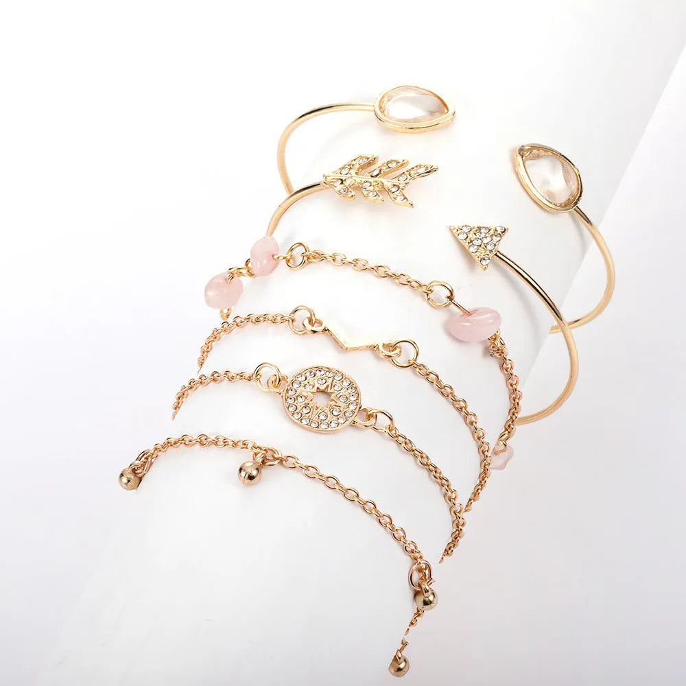 Gold zinc alloy bracelet set with six pieces showing arrow and water drop charms