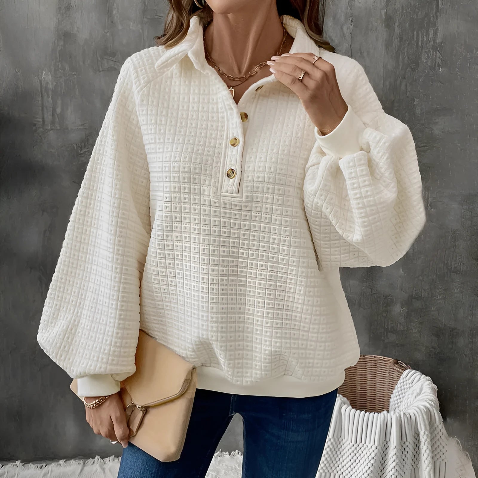 Beige women's textured knit sweater with a polo collar and long sleeves.