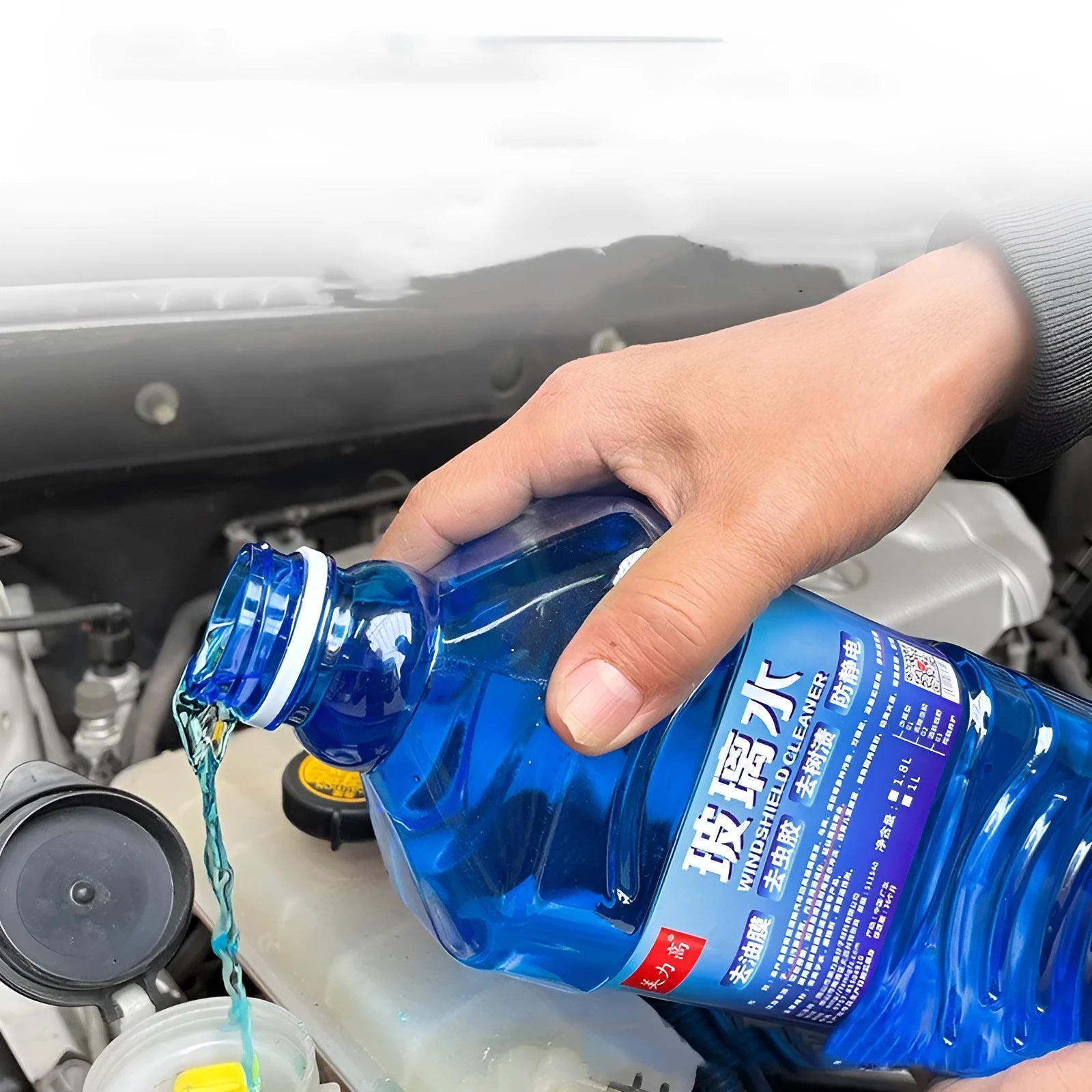 Blue 1L windshield washer fluid bottle with 0°C label for car windscreen cleaning